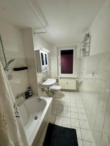 a white bathroom with a tub and a sink at Ferien- und Monteurwohnung in Borna Nr 5 in Borna