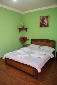 a bedroom with a bed with white towels on it at Hotel Kvareli in Tbilisi City