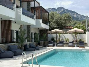 a hotel with a swimming pool and a building at Oli Terra in Skala Potamias