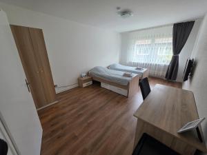 a small room with a bed and a table at 3-Zimmer Wohnung - 3 OG in Duisburg