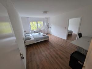 a large room with a bed and a window at 3-Zimmer Wohnung - 3 OG in Duisburg +6 photos
