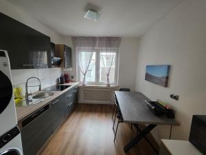 a small kitchen with a table and a sink at 3-Zimmer Wohnung - 3 OG in Duisburg