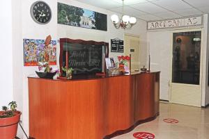 a counter in a restaurant with a clock on the wall at Hotel Mesón del Rey in Oaxaca City