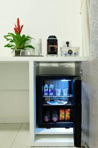 a small refrigerator under a counter with drinks in it at La Piazza in Ancona