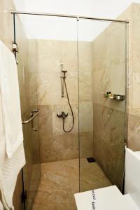 a bathroom with a shower with a glass door at Samindra Villa in Kandy +62 photos