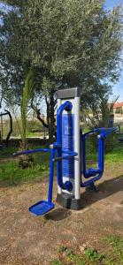 a blue and white gas pump in a park at Perivleptos Ι in Perdika