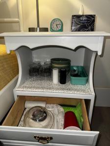 a drawer in a refrigerator with dishes and a clock at Peaceful in Moncton +10 photos