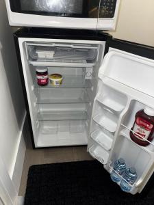 an open refrigerator with its door open and itsartmentsternessternessternessstrationstrationterness at Peaceful in Moncton