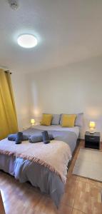a large bed with pillows on it in a room at Casa Vereda do Calhau - With barbecue in Campanário