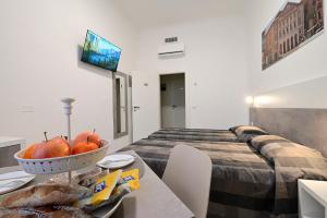 a bedroom with a bed and a table with a bowl of fruit at La Piazza in Ancona +51 photos
