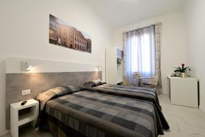 a hotel room with a bed and a window at La Piazza in Ancona