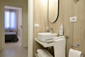 a bathroom with a sink and a mirror at La Piazza in Ancona