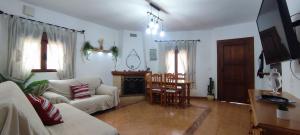a living room with a couch and a table at La Virgen del Mar in Las Hortichuelas Bajas