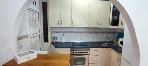 a kitchen with white cabinets and a stove top oven at La Virgen del Mar in Las Hortichuelas Bajas