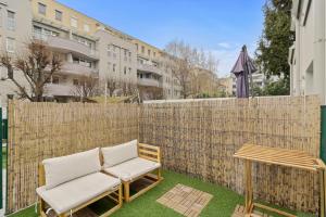 a patio with two chairs and a table and a fence at U1 Metro Nearby - 1-BR - fast Wi-Fi in Vienna