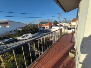 a balcony with a view of a street at GamaBarros1-Charneca in Charneca