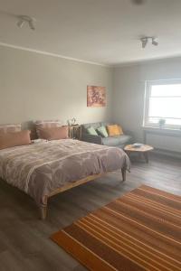 a bedroom with a large bed and a couch at Apartment Becker by Interhome in Bad Neuenahr-Ahrweiler +2 photos