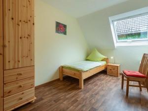 a small bedroom with a bed and a window at Apartment Alexandra by Interhome in Wintrich