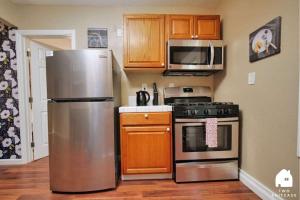 a kitchen with a stainless steel refrigerator and microwave at Central Berkeley Garden Oasis in Berkeley