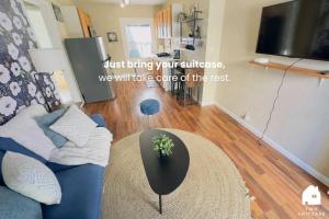 a living room with a blue couch and a table at Central Berkeley Garden Oasis in Berkeley