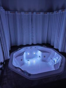 a white bath tub sitting in front of a window at chalé com Hidro e Vista panorâmica para Serra in Paraisópolis +82 photos