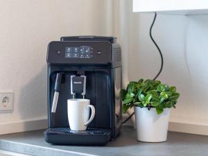 a coffee maker on a counter next to a plant at Apartment Apartment 54 by Interhome in Bad Arolsen