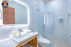 a bathroom with a toilet and a sink and a shower at Mountain Top Park Hotel in Manuel Antonio +135 photos