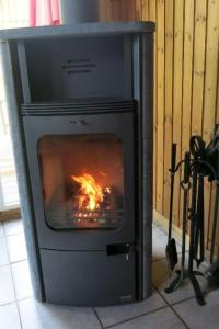a fireplace with a fire in it in a room at Holiday Home Marx by Interhome in Bremke