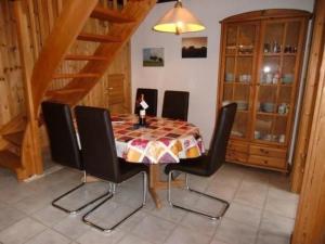 a dining room with a table with black chairs at Holiday Home Marx by Interhome in Bremke
