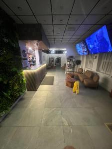 a living room with couches and televisions at Hotels 24-7 - The Old Victoria Hotel in Newport
