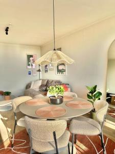 a living room with a table and chairs at Joy at sea in Bredene-aan-Zee