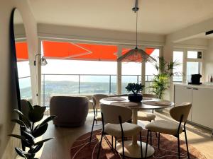 a kitchen and dining room with a table and chairs at Joy at sea in Bredene-aan-Zee