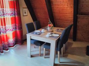 a dining room table with chairs and a white table with at Holiday Home Kirschblüte by Interhome in Ronshausen +11 photos
