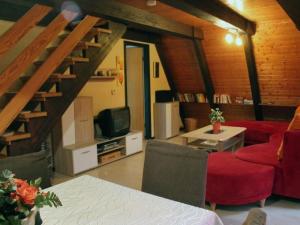 a living room with a red couch and a tv at Holiday Home Kirschblüte by Interhome in Ronshausen