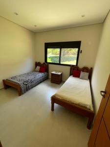 a bedroom with two beds and a window at Casa represa Piracaia in Piracaia +47 photos