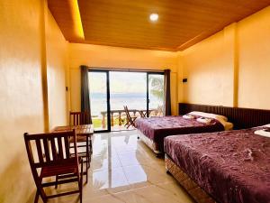 a bedroom with two beds and a view of the ocean at Rio Beach Resort in Alegria +54 photos