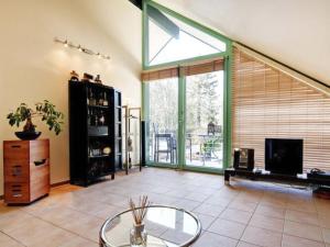 a living room with a large window and a fireplace at Apartment Immas Welt by Interhome in Utting am Ammersee