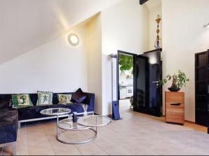 a living room with a couch and a table at Apartment Immas Welt by Interhome in Utting am Ammersee +11 photos