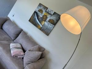 a living room with a couch and a lamp at Apartment Kommerswag by Interhome in Pittenbach