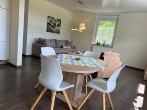 a dining room and living room with a table and chairs at Apartment Kommerswag by Interhome in Pittenbach
