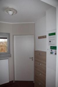 a white room with a door and a window at Holiday Home Adele - Allergiker geeignet by Interhome in Zandt