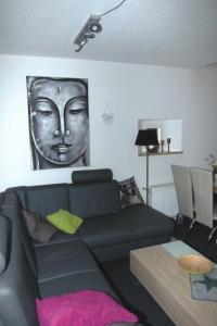 a living room with a black couch and a table at Holiday Home Adele - Allergiker geeignet by Interhome in Zandt +26 photos