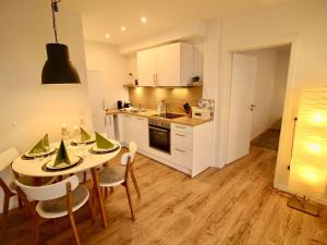 a kitchen and dining room with a table and chairs at Apartment Feldblick by Interhome in Hartheim