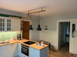 a kitchen with white cabinets and a sink at Apartment Seerose by Interhome in Bleckede