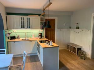 a kitchen with white cabinets and a counter top at Apartment Seerose by Interhome in Bleckede