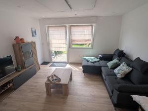 a living room with a couch and a coffee table at Apartment Wittle by Interhome in Weiler-Simmerberg