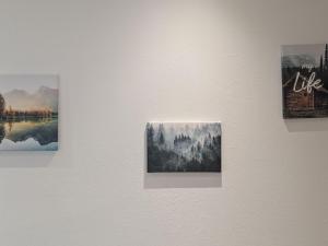 three paintings on a white wall in a museum at Apartment Wittle by Interhome in Weiler-Simmerberg