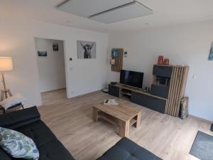 a living room with a couch and a coffee table at Apartment Wittle by Interhome in Weiler-Simmerberg
