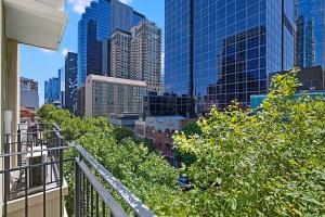 a view of a city skyline from a balcony at Comfort Apartments Melbourne Central in Melbourne