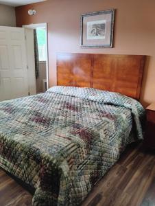 a bedroom with a bed with a wooden head board at Gated 1 King BR1 Bath Apt with Full Kitchen 124 in Baton Rouge